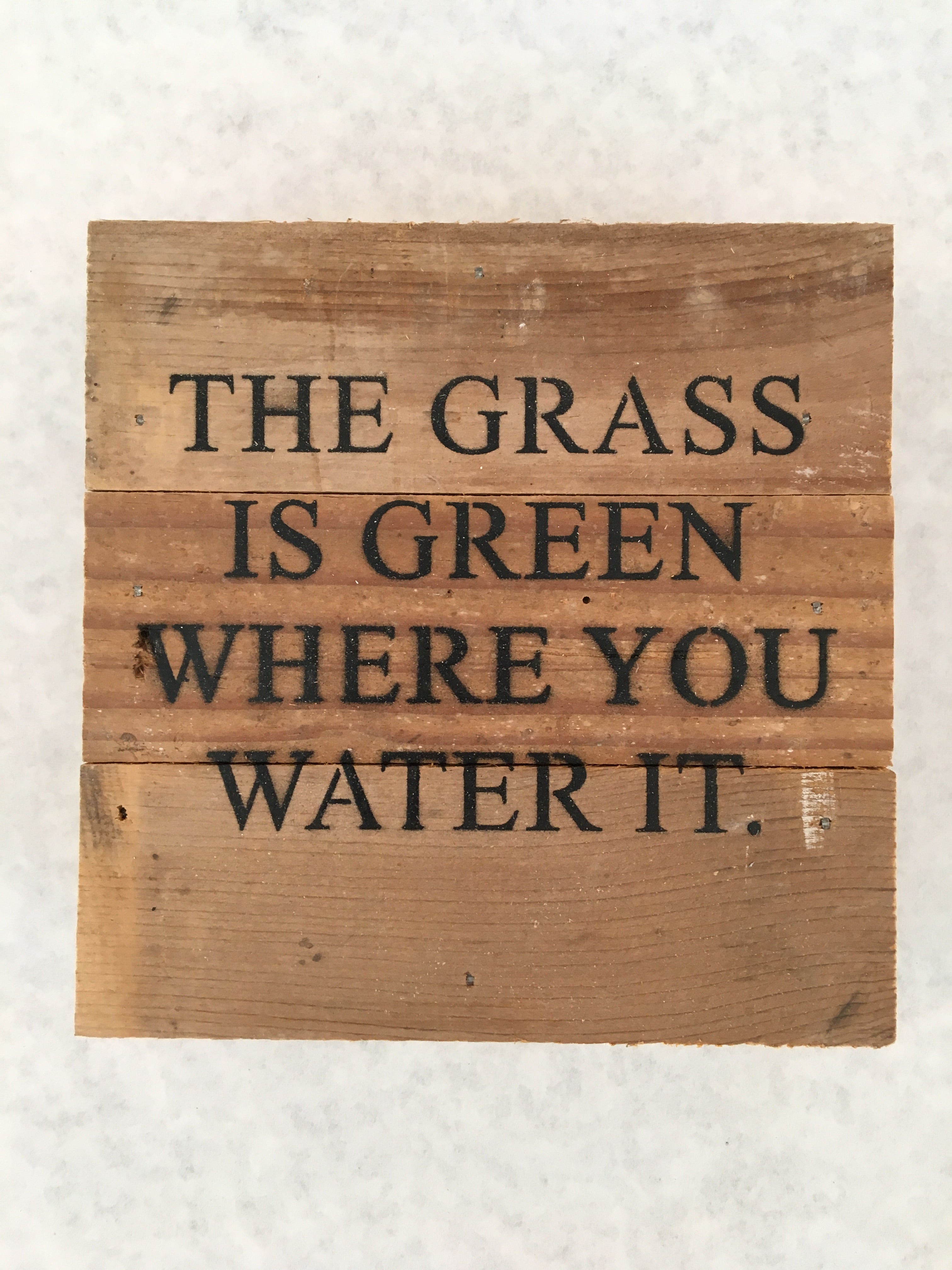 the grass is green sign