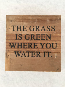 the grass is green sign